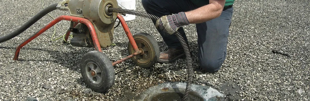 sewer rodding technician actively removing blockages from a sewer line in Atlanta, GA